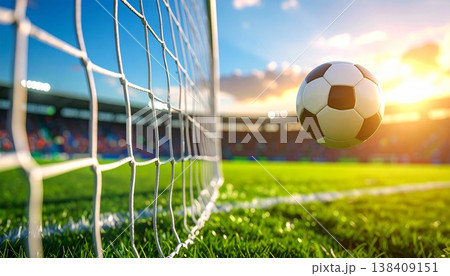 サッカーボールがゴールネットに当たる瞬間の躍動シーン 138409151