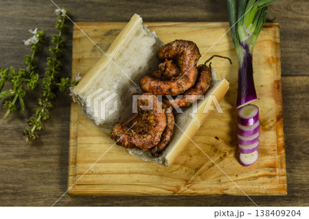 Cow bowels presented on a wooden board with ingredients, ready to grill Cow bowels presented on a wooden board with ingredients, ready to grill 138409204