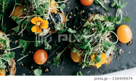 Fresh Avocado Toast with Cherry Tomatoes and Edible Flowers 138409974