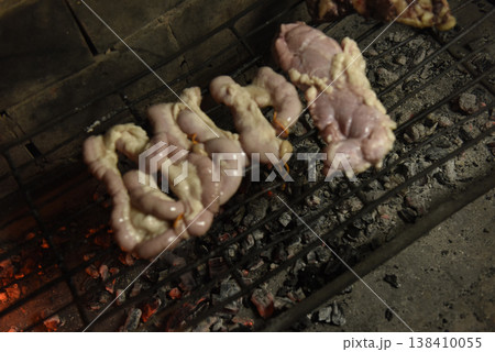 Cow bowels presented on a grill. Argentine Traditional cuisine. 138410055