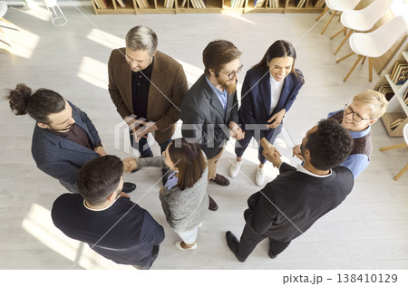 Diverse business team in office handshake meeting, top view corporate networking Diverse business team in office handshake meeting, top view corporate networking 138410129