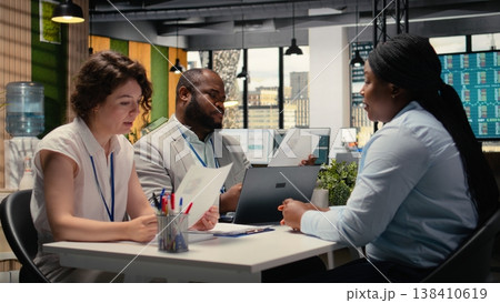 Diverse hiring team and black candidate discuss about qualifications for a job opening within the business organization. Evaluating CV resume information, head hunting concept. Camera A. Diverse hiring team and black candidate discuss about qualifications for a job opening within the business organization. Evaluating CV resume information, head hunting concept. Camera A. 138410619