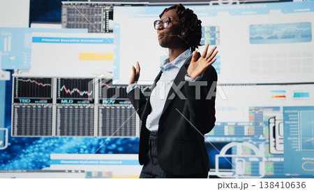 Manager speaking at professional fintech convention, showing business market graphs to shareholders. Businesswoman presenting financial reports and data charts infographics on digital screen, camera A 138410636