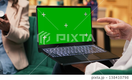 Green screen laptop with senior doctor recommending pills and vitamins as treatment used for recovery and wellbeing, private healthcare insurance. Woman medic consulting old man. Green screen laptop with senior doctor recommending pills and vitamins as treatment used for recovery and wellbeing, private healthcare insurance. Woman medic consulting old man. 138410798