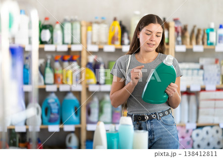 woman chooses detergents and rinses woman chooses detergents and rinses 138412811