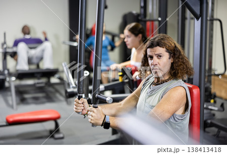 European athlete works on special simulator for development of pectoral muscles 138413418