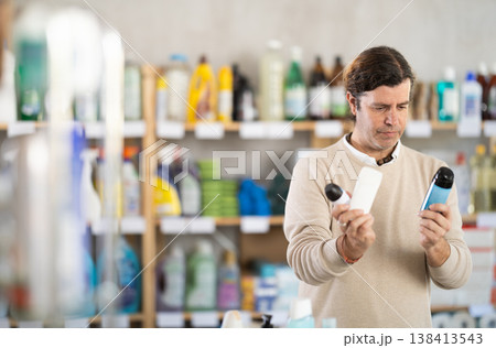 Man choosing deodorants in supermarket 138413543
