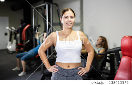 Caucasian fitness instructor woman standing in gym Caucasian fitness instructor woman standing in gym 138413573
