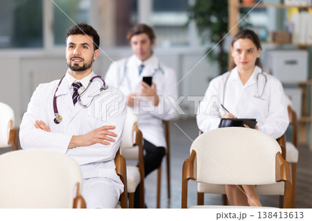Medical students or doctors attending training session in modern lecture room 138413613