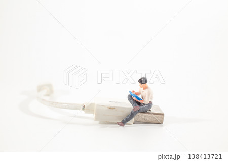 A Miniature worker striking worn charging cable 138413721
