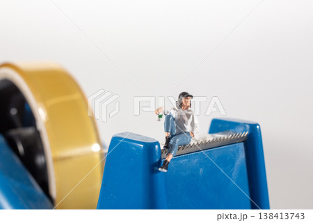 Miniature figures standing together in bright lineup Miniature figures standing together in bright lineup 138413743
