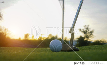Golf clubs and balls on a green lawn in a beautiful golf course with morning sunshine. 138414360