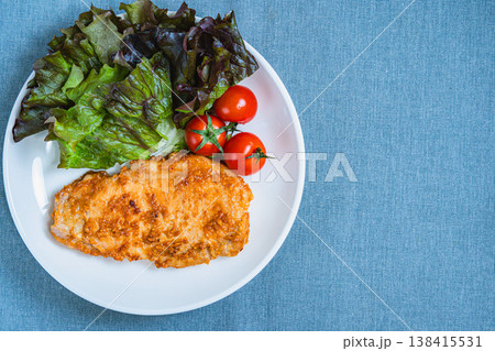 味噌漬けトンテキとサニーレタスとミニトマトのプレート料理 白い皿の家庭料理 138415531