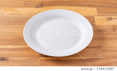 Empty white plate on wooden table with copy space Empty white plate on wooden table with copy space 138415997