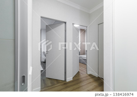 Modern Apartment Hallway with Multiple Grey Invisible Doors 138416974