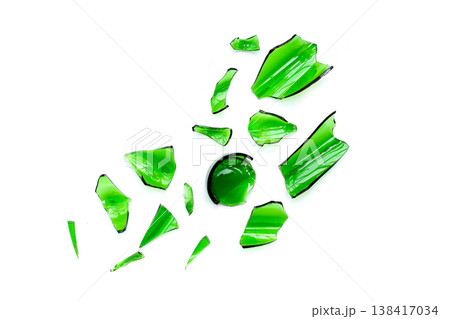 Sharp green glass shards scattered on a white background. Sharp green glass shards scattered on a white background. 138417034