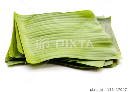 Stacked banana leaves on a white background, commonly used in traditional cooking. Stacked banana leaves on a white background, commonly used in traditional cooking. 138417047