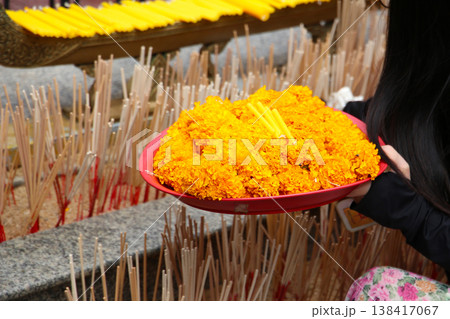 Marigold flower garlands offered for worship at the Erawan Shrine in Bangkok, Thailand. Marigold flower garlands offered for worship at the Erawan Shrine in Bangkok, Thailand. 138417067