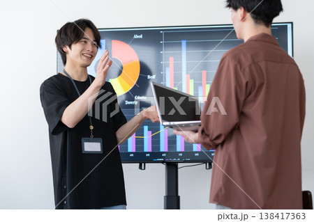 オフィスのパソコンで仕事をする若い男性エンジニア オフィスのパソコンで仕事をする若い男性エンジニア 138417363