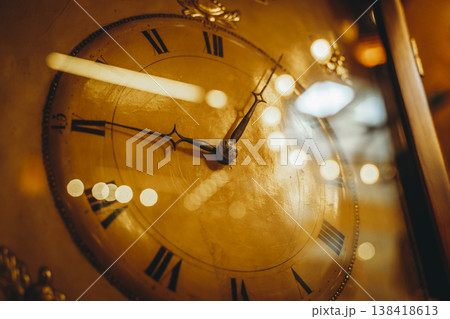 Vintage Antique Clock Face with Roman Numerals and Warm Lighting 138418613