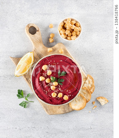 Beetroot hummus with parsley and olive oil in plate on a gray background, top view. Copy space. Arabic, Turkish cuisine. 138418766