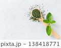 Dried mint leaves in wooden spoon with fresh mint on white background. Copy spice. Herbal medicine.  138418771