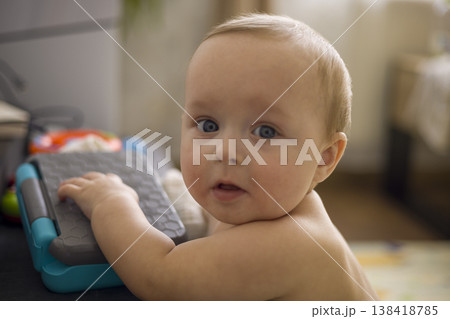 Caucasian Infant Exploring Toy Keyboard On Floor, Hands On Keys, Inquisitive Expression, Soft Natural Window Light, Early Music Play And Sensory Discovery Scene Caucasian Infant Exploring Toy Keyboard On Floor, Hands On Keys, Inquisitive Expression, Soft Natural Window Light, Early Music Play And Sensory Discovery Scene 138418785