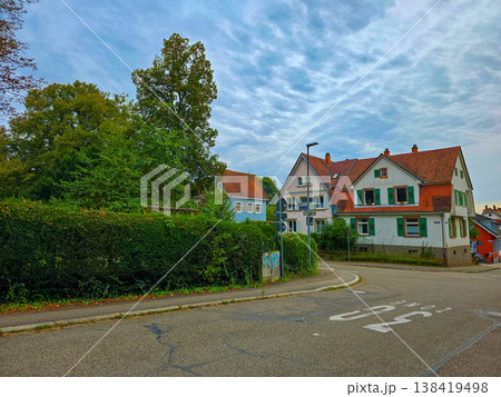 Charming street view in a European town with a traditional house covered in red ivy. 138419498