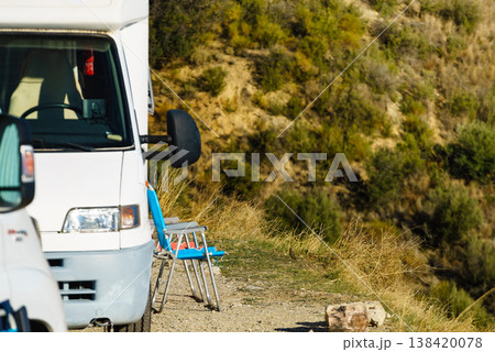 Rv motorhome with two chairs ready for outdoor living. Camping on nature 138420078
