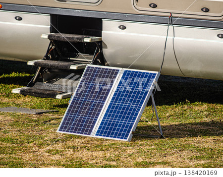 Portable solar photovoltaic panel, charging battery at camper vehicle. Portable solar photovoltaic panel, charging battery at camper vehicle. 138420169