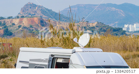 Caravan with satellite dish on roof camping on spanish nature Caravan with satellite dish on roof camping on spanish nature 138420517