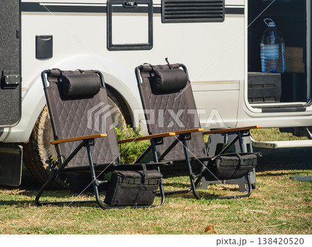 Camper car and tourist chairs on spanish sea coast. Resting on seaside. Camper car and tourist chairs on spanish sea coast. Resting on seaside. 138420520