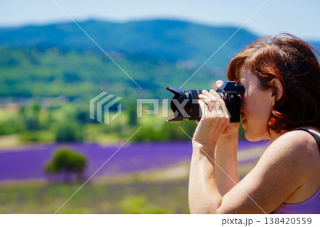 Tourist woman take photo on lavender field, Vaucluse department in Provence France Tourist woman take photo on lavender field, Vaucluse department in Provence France 138420559
