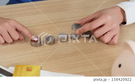 Hands organizing coins for financial planning 138420922
