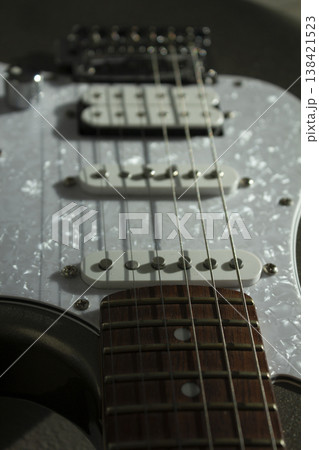 This is a close-up of the electric guitar strings. 138421523