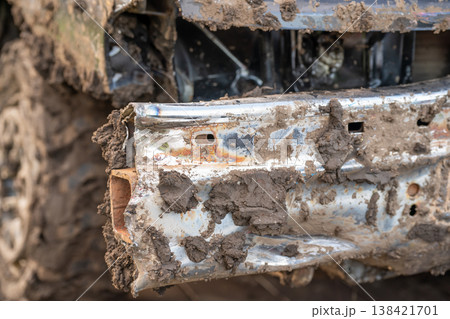Dented and damaged rear end of a modified car used for a demolition derby. 138421701