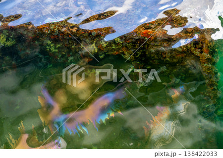 Water surface shows oil sheen over the USS Arizona Memorial at the Pearl Harbor National Park in Hawaii  138422033