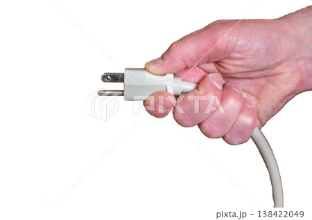 White background with a hand grasping a power cord to plug in. White background with a hand grasping a power cord to plug in. 138422049