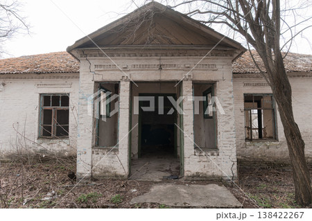 Abandoned White Brick Schoolhouse With Green Trim And Broken Windows Showing Decay In Overgrown Yard During Early Spring Season Abandoned White Brick Schoolhouse With Green Trim And Broken Windows Showing Decay In Overgrown Yard During Early Spring Season 138422267