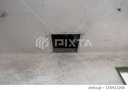 Weathered White Ceiling With Cracks And Dark Rectangular Opening Showing Interior View In Abandoned Building Scene 138422268