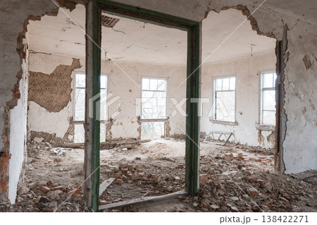 Abandoned Dilapidated Room With Crumbling Walls, Scattered Bricks, Green Door Frame, and Broken Windows Showing Decay Texture Abandoned Dilapidated Room With Crumbling Walls, Scattered Bricks, Green Door Frame, and Broken Windows Showing Decay Texture 138422271