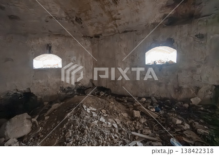 Dilapidated Stone Room With Arched Windows And Debris Pile Showing Weathered Walls, Rough Textures, Gray Tones, Abandoned Interior Scene Dilapidated Stone Room With Arched Windows And Debris Pile Showing Weathered Walls, Rough Textures, Gray Tones, Abandoned Interior Scene 138422318
