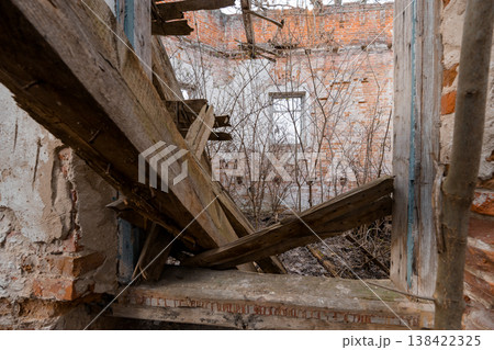 Dilapidated Wooden Staircase Inside Ruined Brick Building With Overgrown Vines And Broken Planks In Abandoned Interior Scene Dilapidated Wooden Staircase Inside Ruined Brick Building With Overgrown Vines And Broken Planks In Abandoned Interior Scene 138422325