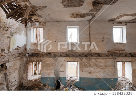 Dilapidated Interior of Abandoned Building Showing Crumbling Walls, Exposed Lath Ceilings, Peeling Paint, Empty Windows, and Debris Scattered Across Floor with Blue and White Color Scheme Dilapidated Interior of Abandoned Building Showing Crumbling Walls, Exposed Lath Ceilings, Peeling Paint, Empty Windows, and Debris Scattered Across Floor with Blue and White Color Scheme 138422329