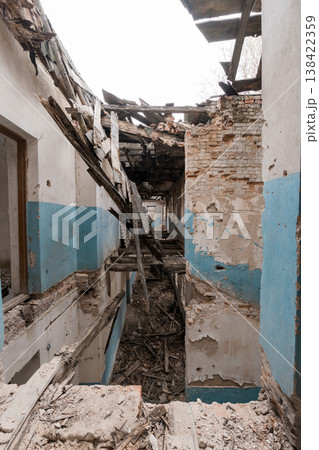 Dilapidated Corridor With Exposed Brick And Blue Paint Showing War Damage Or Urban Decay In Abandoned Building Interior 138422359
