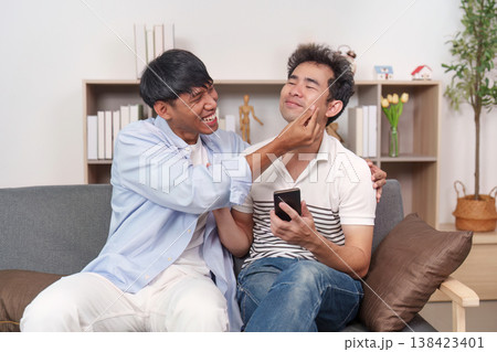 LGBTQ couple sharing a playful moment at home LGBTQ couple sharing a playful moment at home 138423401
