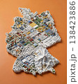 Miniature cityscape shaped as Germany map on flat background - ai generated 138423886