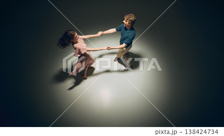 Happy couple dancing lindy hop smiling in motion studio lifestyle active scene. 138424734