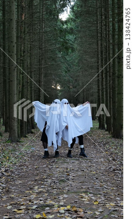 Two People in Ghost Costumes Walking on a Forest Path Two People in Ghost Costumes Walking on a Forest Path 138424765