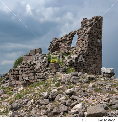 Historic stone ruins of Pergamon ancient city, Bergama, Turkey, under a dramatic cloudy sky Historic stone ruins of Pergamon ancient city, Bergama, Turkey, under a dramatic cloudy sky 138425022